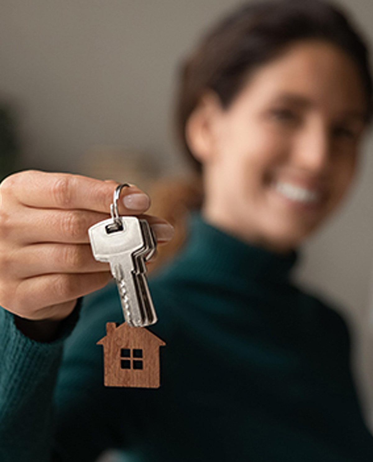 fuzzy image of woman holding keys on a keychain