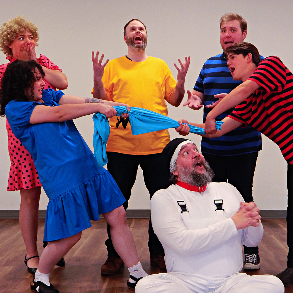 Six actors in colorful costumes strike dramatic, playful poses as characters from You’re a Good Man, Charlie Brown.
