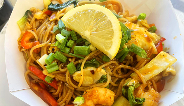 plate of Filipino food with slice of lemon