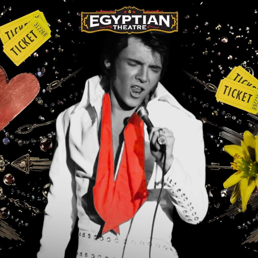 Elvis impersonator in white jumpsuit with red scarf