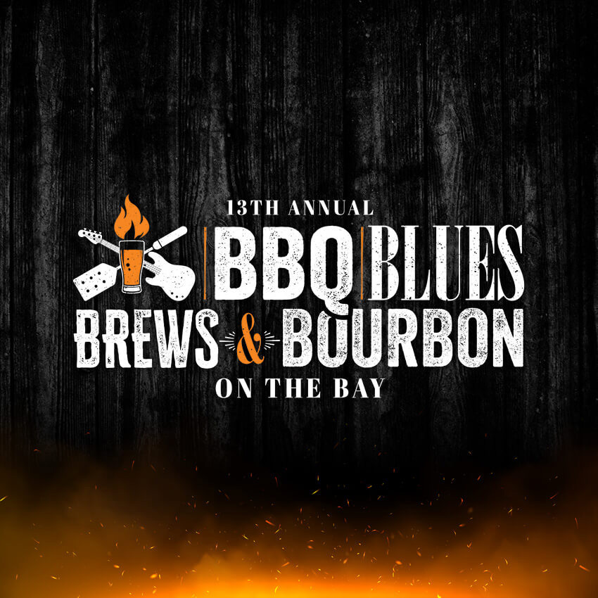 An event poster for the "13th Annual BBQ Blues Brews & Bourbon On The Bay" against a dark, weathered wood background with orange embers at the bottom. To