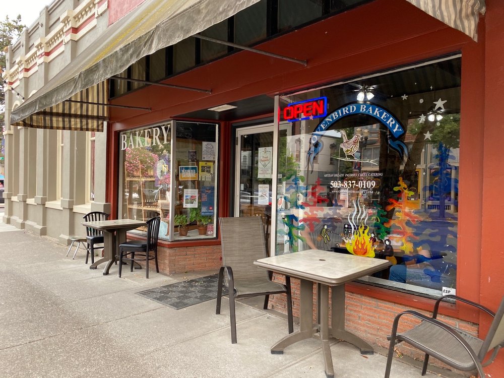 storefront of a bakery with outdoor seating and awning