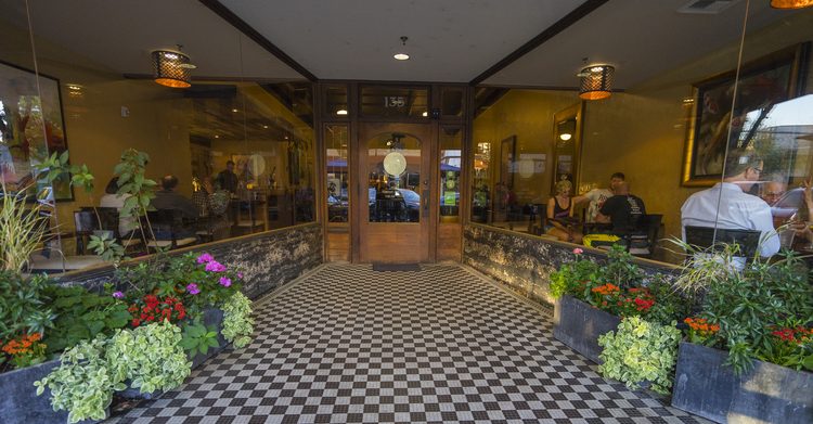 restaurant entrance with checkered tile leading to door