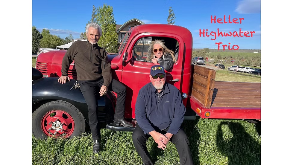 Band members posing in front of vintage red truck