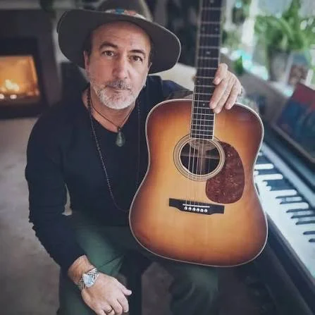 Image of Pete Katsounes holding his guitar