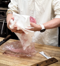 A chef holding a great cut of waygu meat