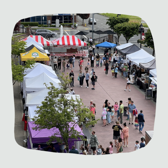 Aerial view of the market with people visiting booths