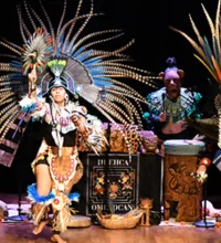 Two people on stage in traditional folk costumes