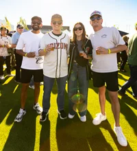 Group of people smiling at camera with beer in hand