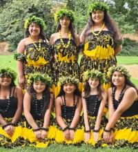 8 young women dressed in traditional Samoa costumes