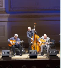 Men on a stage playing stringed instruments