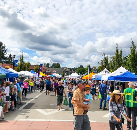 Street with multiple tents and people walking