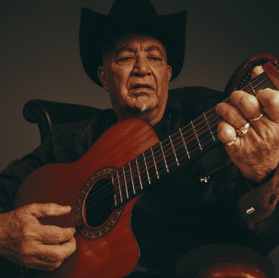 Eliades Ochoa holding a guitar