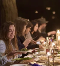 Group of women at a dinner table at night