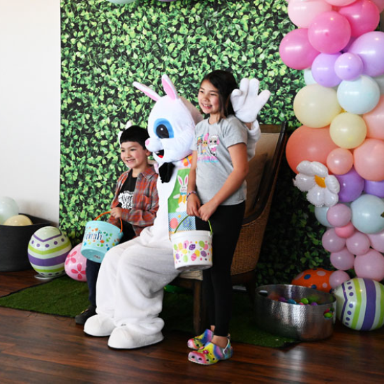 Two kids sitting with the Easter Bunny