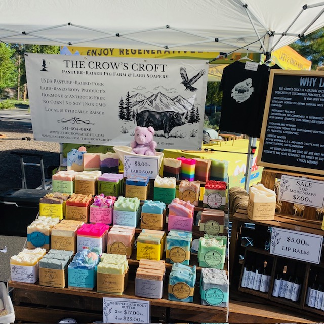 A diverse selection of soaps and lip balms on a vendor table