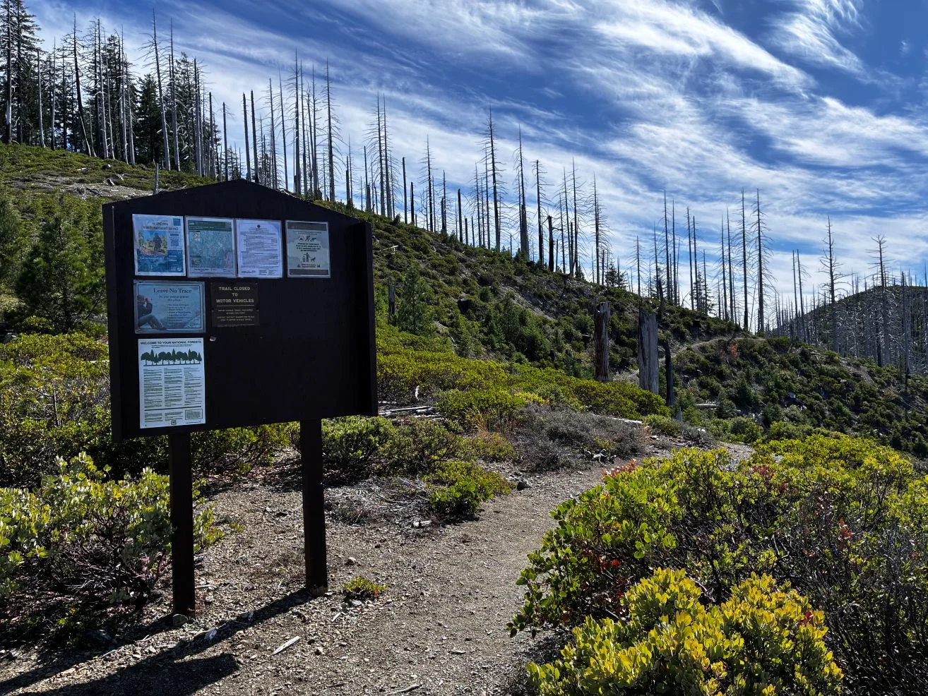 Ridgeline with hiking info posted on Forest Service board.