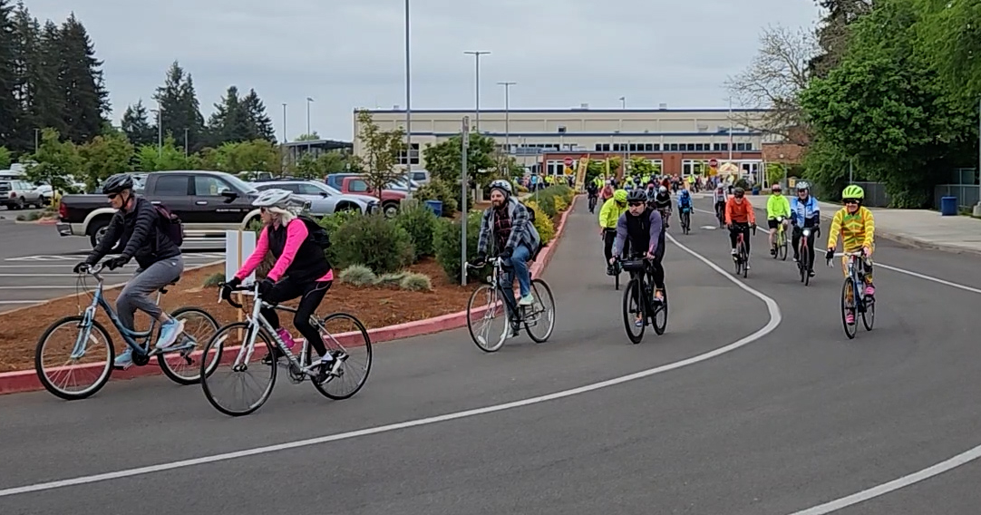 many bicyclers beginning a ride from McNary High School