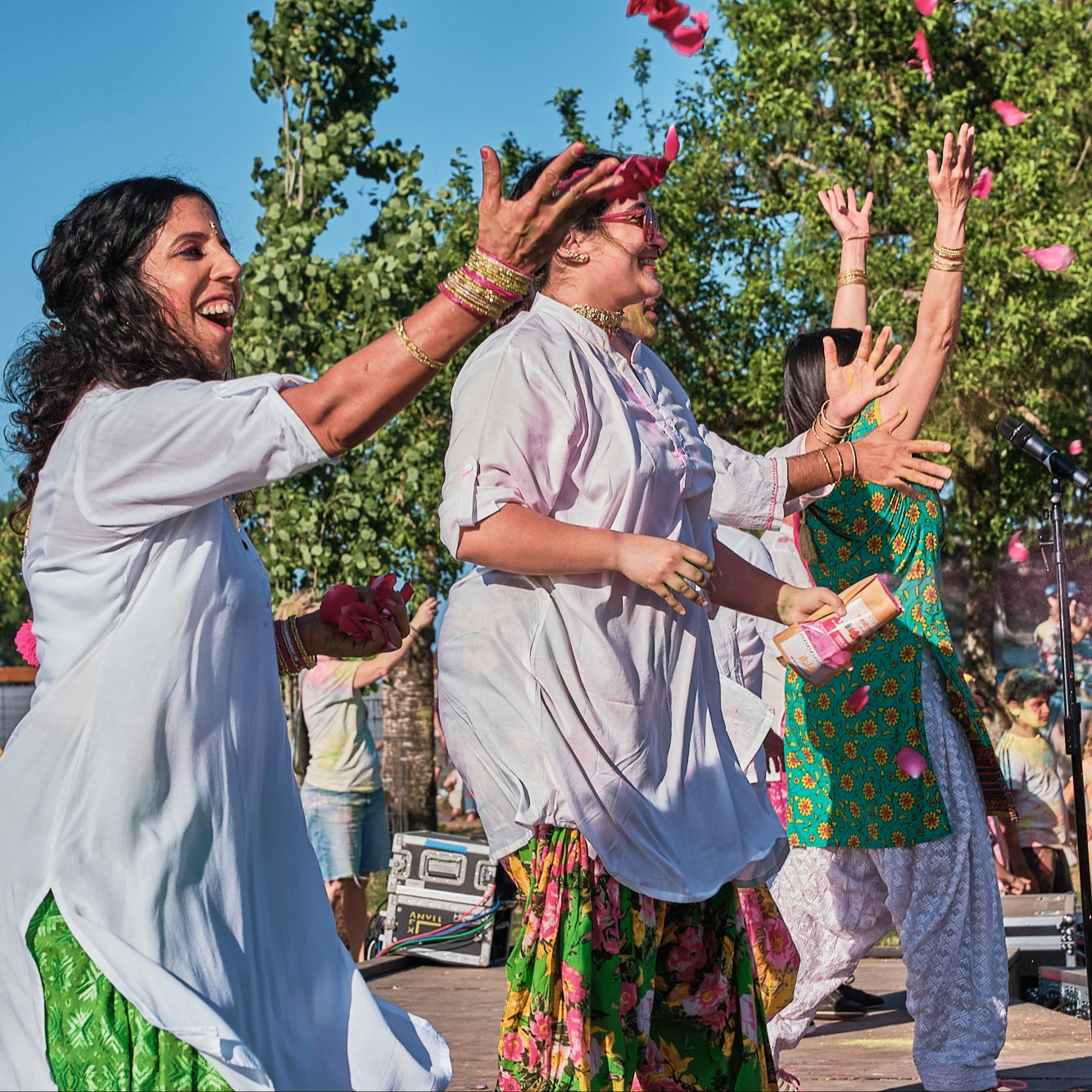 People toss flower petals into the air.