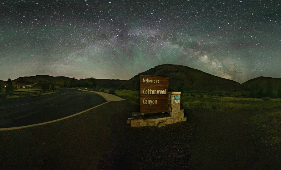 Welcome to Cottonwood Canyon state park sign with the vivid night sky full of stars and the milky way