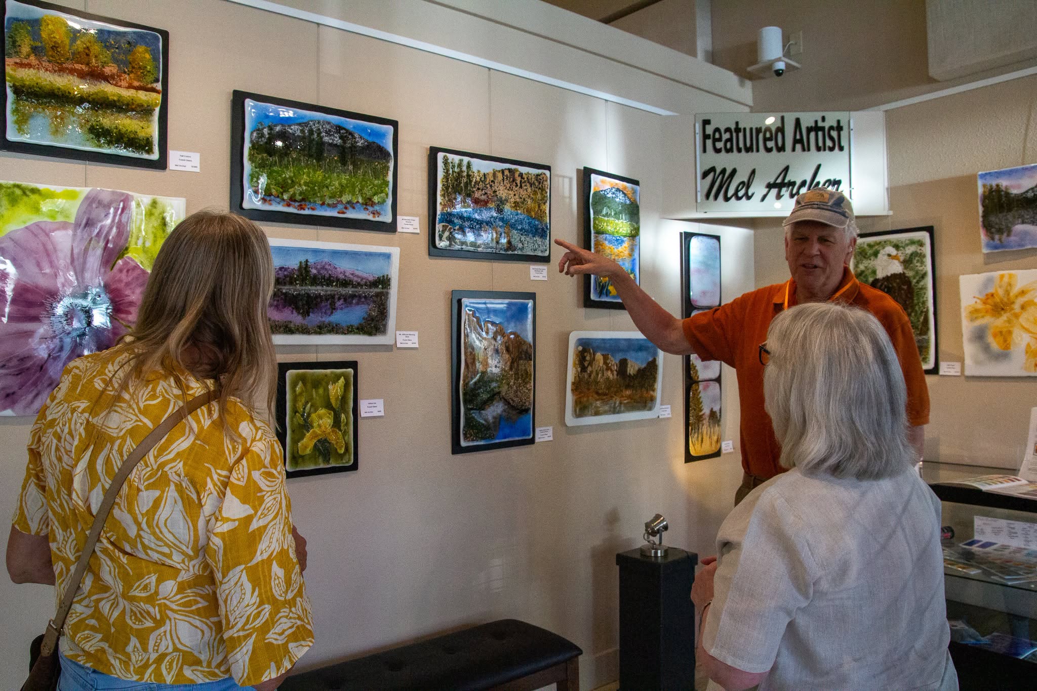 Featured Artist at Dry Canyon Community Art Center showcases his art to customers.